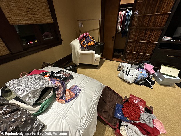 Multiple sets of laundry litter the floors of this bedroom with much of the apparel turned over