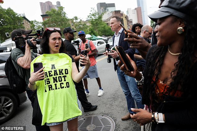 A Diddy fan reacts outside court with a 'freako not a RICO' t-shirt, a reference to the top charge  - racketeering conspiracy