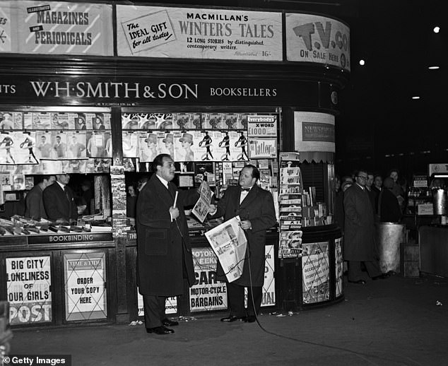 Broadcaster Richard Dimbleby (left) at a WH Smith branch at London Victoria station in 1956