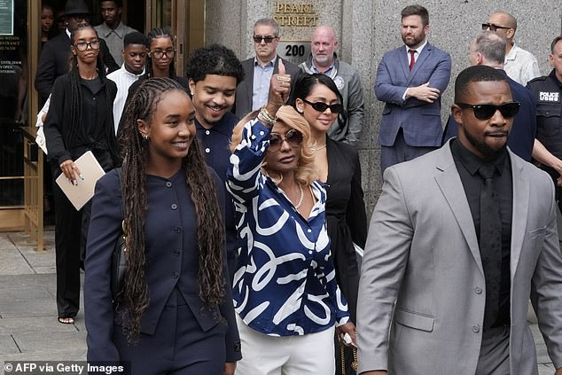 Janice Combs (C), Diddy's mother, gives a thumbs up as she departs with her smiling children and family members at Manhattan's Federal Court on July 2