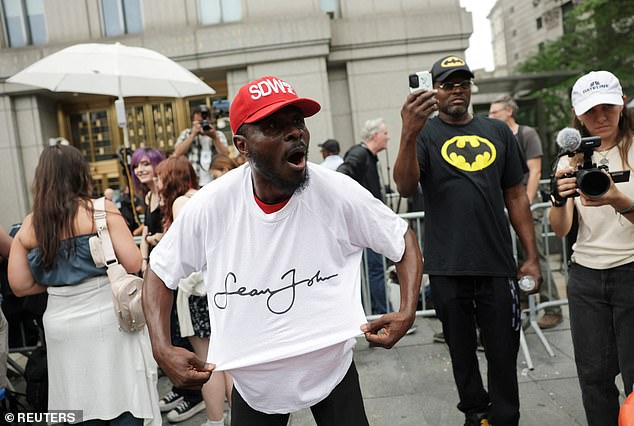 A Diddy supporter celebrates outside court after hearing the verdict
