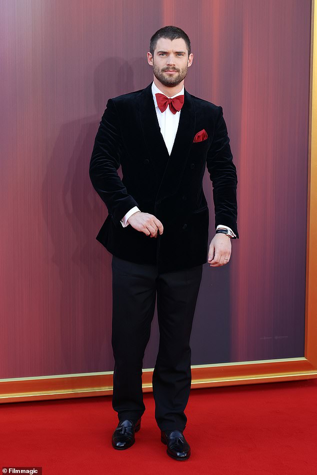 Leading man David wore a dapper black suit and red bow tie