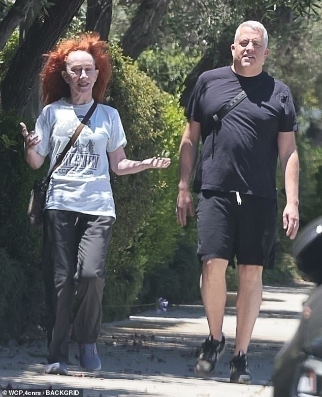 Griffin, who looked to be in high spirits, was joined on her walk by a muscular, gray-haired gentleman wearing all-black