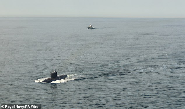 HMS Mersey (seen rear), was scrambled to intercept the Russian boat, alongside a Wildcat helicopter from 815 Naval Air Squadron and Merlin aircraft from 824 Naval Air Squadron
