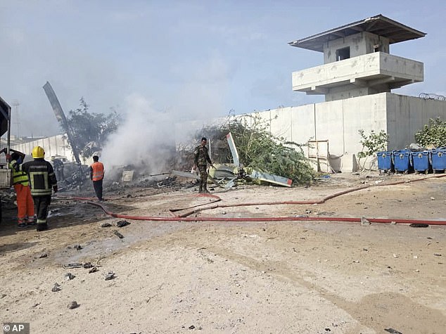 Rescue efforts take place at the site after an African Union military helicopter crashed at Aden Adde airport in Mogadishu, Somalia, on Wednesday, July 2, 2025