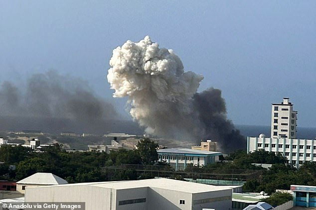 Smoke rises after a helicopter, belonging to the African Union Support and Stabilisation Mission in Somalia (AUSOM), crashes during landing at Aden Adde International Airport in Mogadishu, Somalia on July 2, 2025