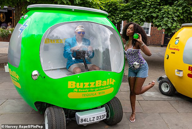 Love Island's Indiyah Polack poses next to the BuzzBallz van – which was handing out free cans – outside Clapham Junction station