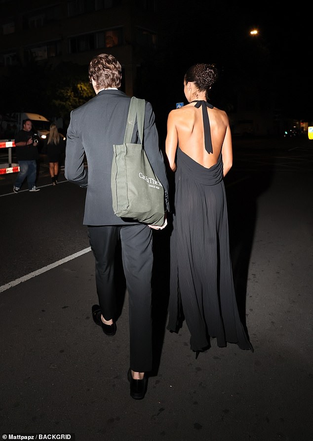 A beaming Bobby led the way through the crowded party exit before the pair were spotted strolling close together to a waiting car