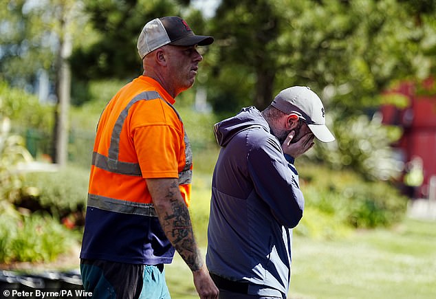 A Liverpool fan cries outside Anfield today