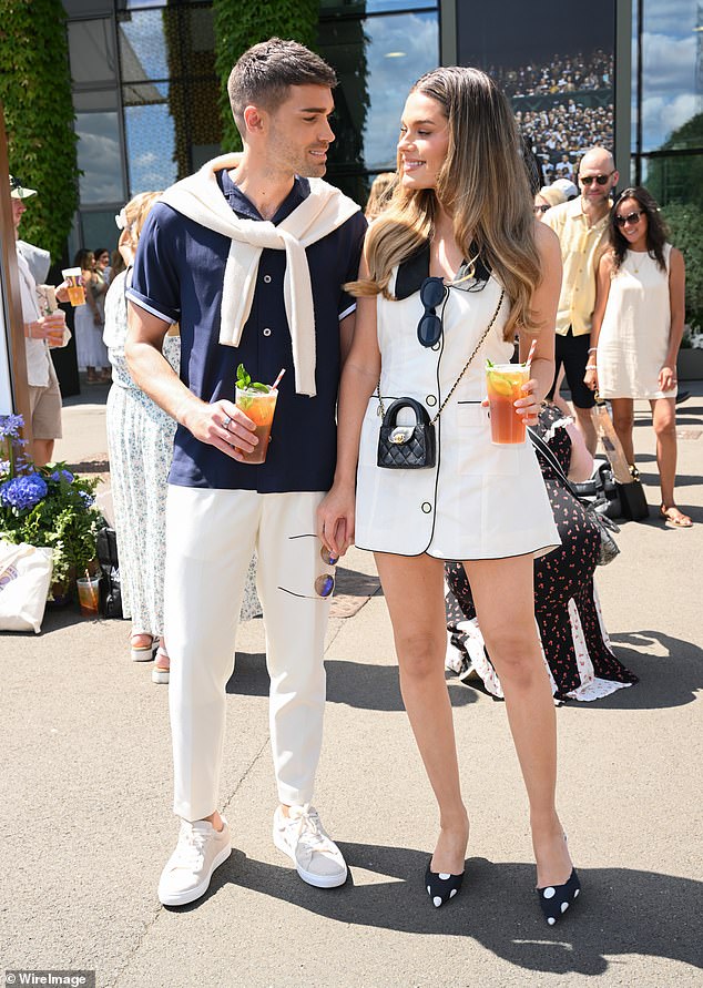 Union J star Josh Cuthbert and and his model wife Chloe Lloyd, who were also in the stands, with Chloe wowing in a white mini dress as they sipped on Pimms