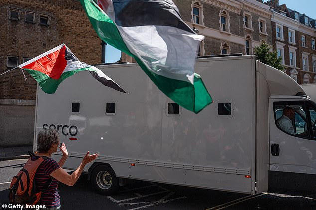 The protesters supporting the activists clapped and cheered as a prison van, believed to be holding the accused, arrived at court