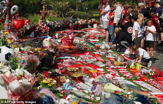 Well-wishers leave flowers at a memorial set up close to Anfield football ground for their Portuguese forward