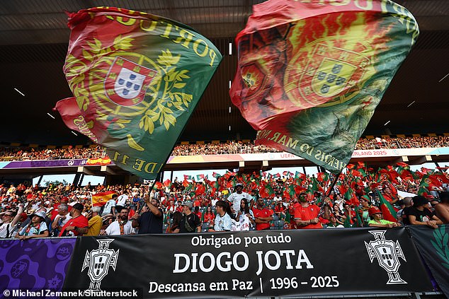 Portugal fans hold up a sign in memory of Diogo Jota ahead of the Spain Women vrs Portugal match