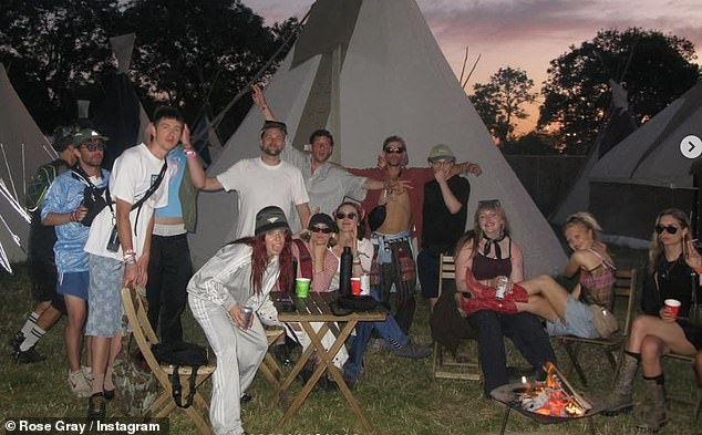The group posed together alongside tipis while drinking and smoking