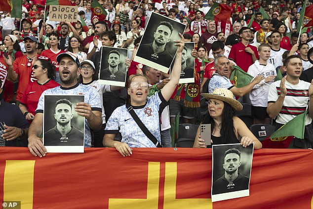 Some fans in the crowd at Switzerland donned signed with Jota's face on and sang his name