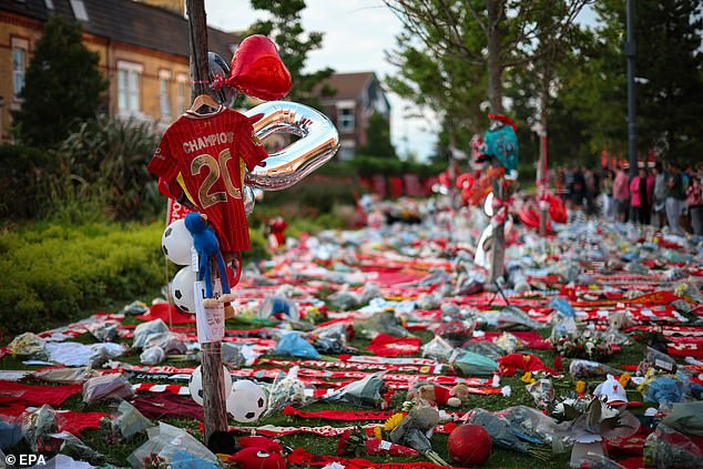 Hundreds of fans laid flowers and scarves outside Liverpool's home stadium on Thursday