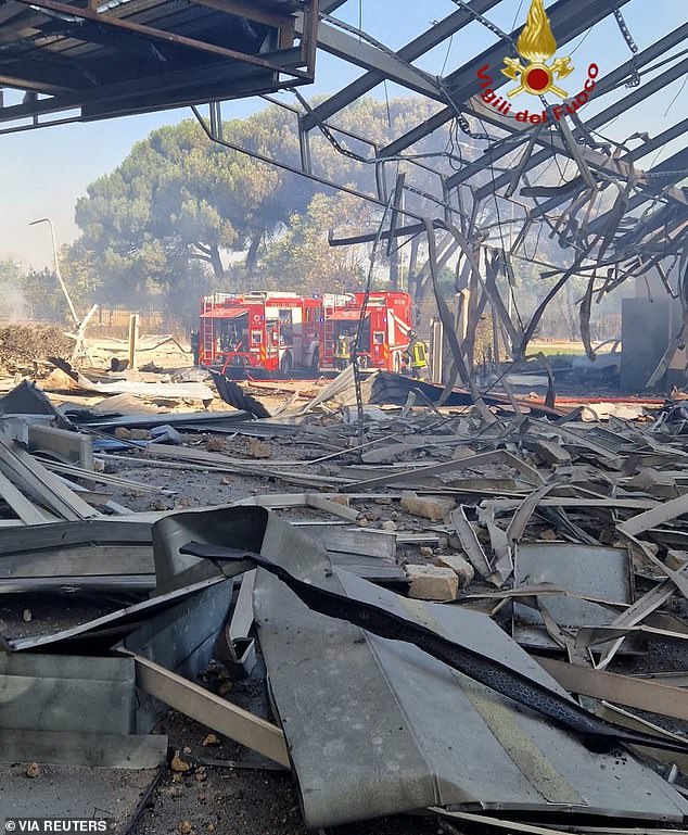 Firefighters are pictured at the scene in the aftermath of several explosions