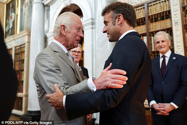 King Charles III talks with President Emmanuel Macron during a reception for European leaders at the European Political Community meeting at Blenheim Palace on July 18, 2024