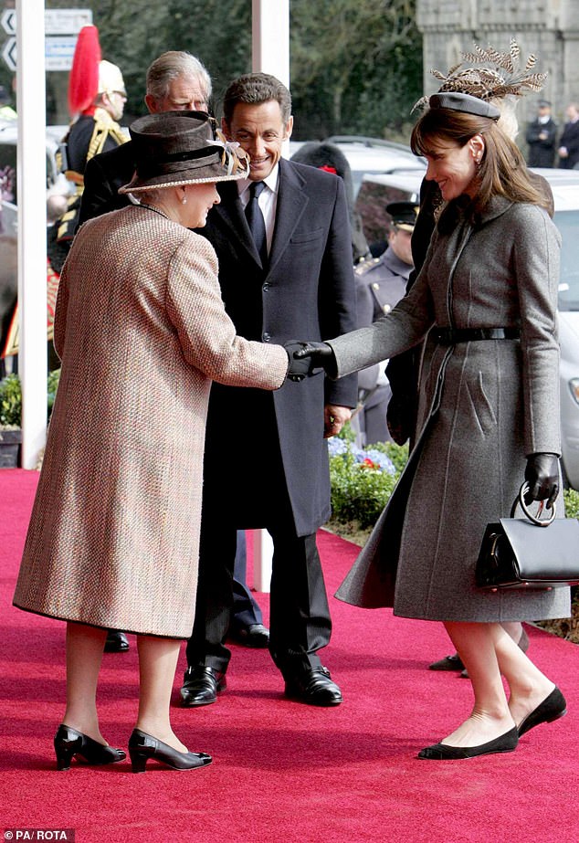 Queen Elizabeth II meets French President Nicolas Sarkozy and his wife Carla Bruni as they arrive at Windsor Castle on March 26, 2008 during the last French state visit to the UK
