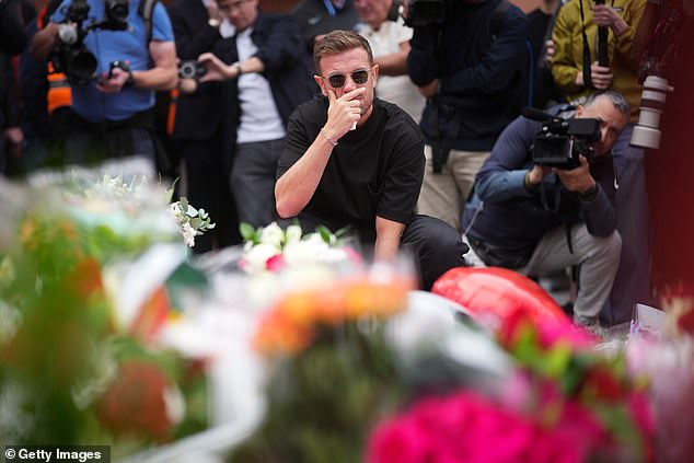 He was emotional as he looked at the flowers and other tributes
