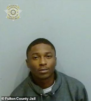 Jabyrion Crumbley(L), 18, was joined by his attorney when he turned himself in to police on July 2 at the Fulton County Jail, where he was booked for murder, aggravated assault and possession of a firearm during the commission of a felony