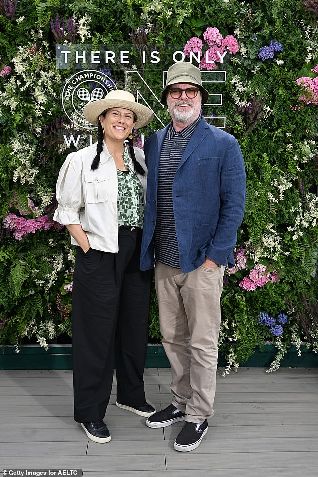 Teaming his blazer with a bucket hat and shades he was joined in the stands by author wife Holiday Reinhorn, whom he married in 1995 and shares son Walter, 21