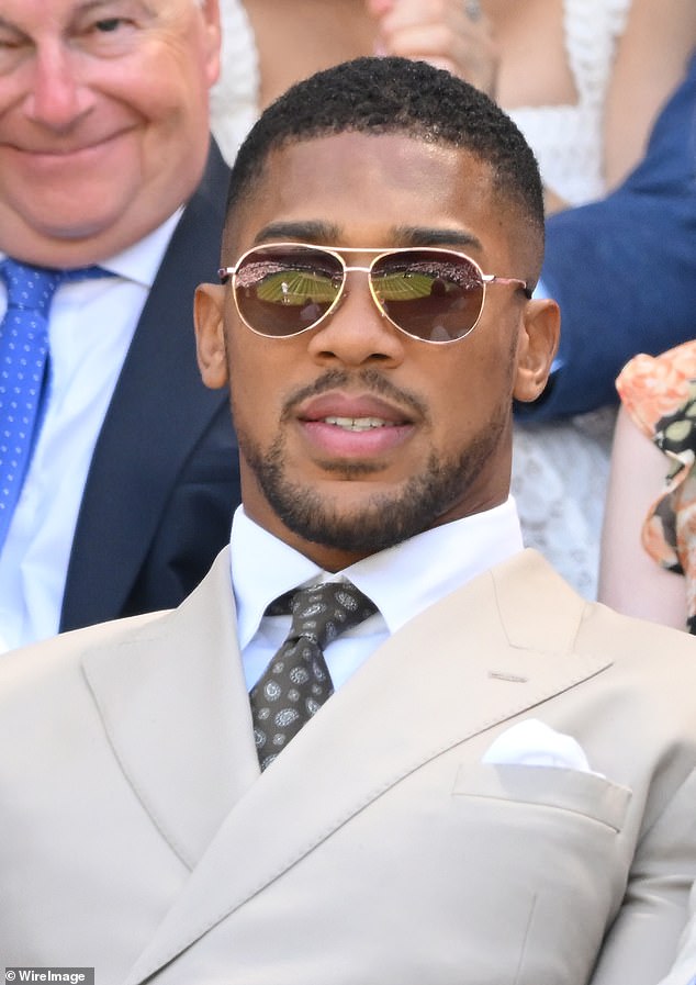 Anthony Joshua, two-time heavyweight champion, donned aviator sunglasses as he watched the action on Centre Court