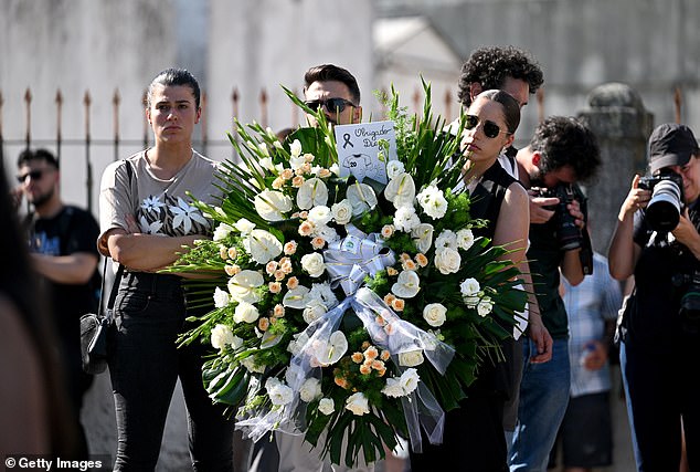 Guests carry a wreath of flowers at a public wake held for Diogo Jota and his brother Andre Silva at the Capela da Ressurreicao on July 04, 2025 in Gondomar, Portugal