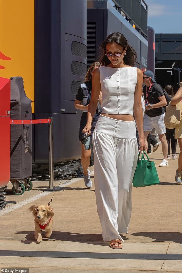 The influencer looked chic in a white co-ord by PrettyLittleThing while walking her adorable dog Leo through the grounds