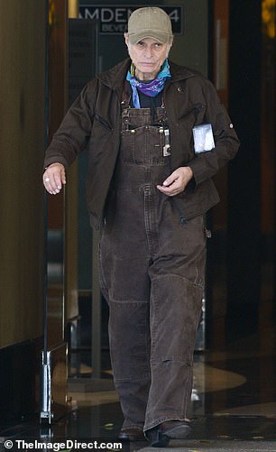 He added a black shirt underneath and slipped into a pair of brown boots to complete the overall outfit