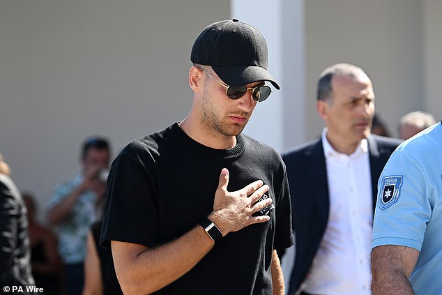 Manchester United player and Jota's Portugal teammate Diogo Dalot arrives at the wake looking pensive