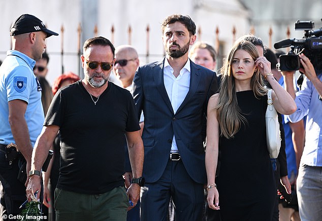 Manchester City star Bernardo Silva (c), a fellow member of the Portguese national team, arrives for Jota's wake with wife Ines Tomaz (r)