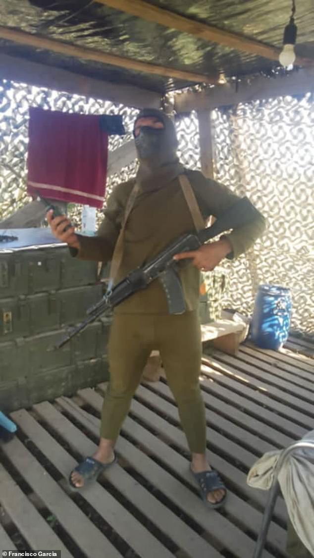 Francisco wearing a face mask and holding a Russian-issue weapon - he says he only ever 'shot in a panic' but is haunted by the idea he may have wounded or even killed Ukrainian soldiers