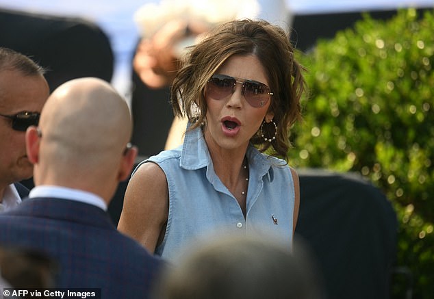 Department of Homeland Security Secretary Kristi Noem sported aviators and a denim vest at Friday's Fourth of July celebration where President Donald Trump signed into law his 'Big, Beautiful Bill'