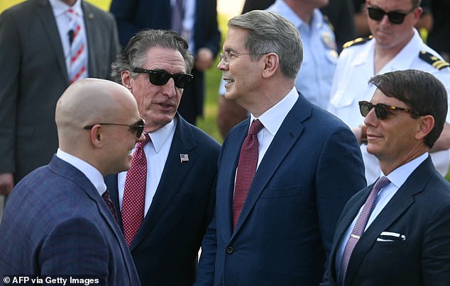 Interior Secretary Doug Burgum (left) and Treasury Secretary Scott Bessent (center) chat on the South Lawn alongside Hogan Gidley (right), who worked for the first Trump administration