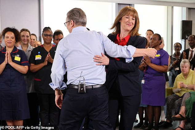 Prime minister Keir Starmer (left) and chancellor Rachel Reeves (right) embrace during a visit to the Sir Ludwig Guttmann Health and Wellbeing Centre in east London on July 3, 2025
