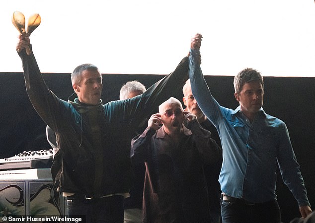 After reaching the front of the stage, the brothers proved they've finally overcome their differences as they stood hand-in-hand gazing out over the sea of supporters