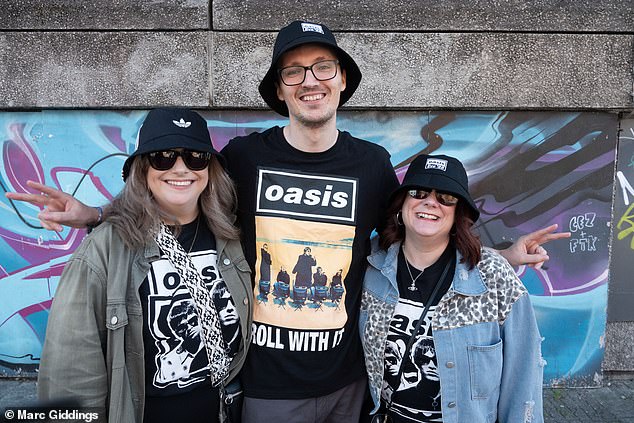 The streets of Cardiff were rammed ahead of Oasis's opening night with Wonderwall blasting from work vans while superfans are queuing up to purchase bucket hats and T-shirts [pictured: Jarreth, Holly and Sarah from Bridgend, South Wales]