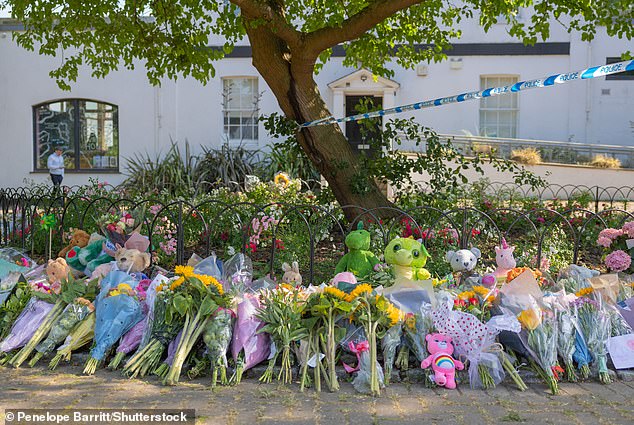 An ever-growing carpet of floral tributes and teddy bears left by locals near to where the tragedy happened