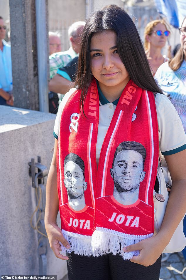 A mourner at the Chapel of Rest wearing a football scarf paying tribute to Diogo Jota