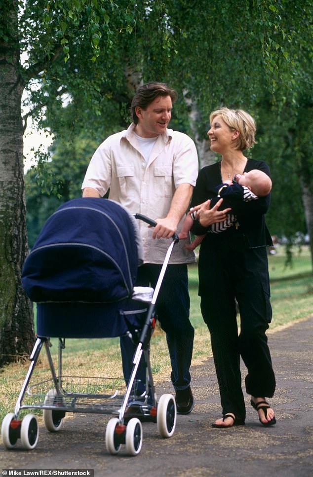 New parents: Fiona and Martin walk through a park with a pram and their new child in 1999