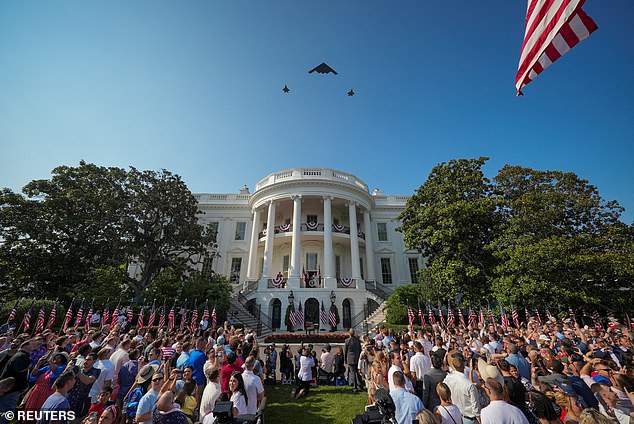 The crowd watches as a B-2 bomber and two F-35 jets fly over the White House during Fourth of July celebrations on Friday