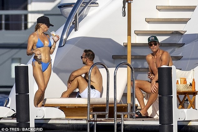 He was seen sitting in a chair on an open area of the yacht and mingled with both Hudson and Johnson
