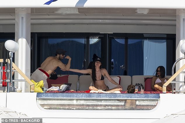 Dakota was then seen placing her hand on his muscular bicep before he took a seat next to the Hollywood actress