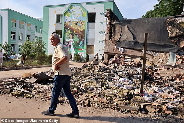 A man walks amid rubble at a residential district in the Ukrainian capital of Kyiv on July 4, 2025, after Russia launched a mass attack against their neighbours using a record 539 drones and 11 missiles