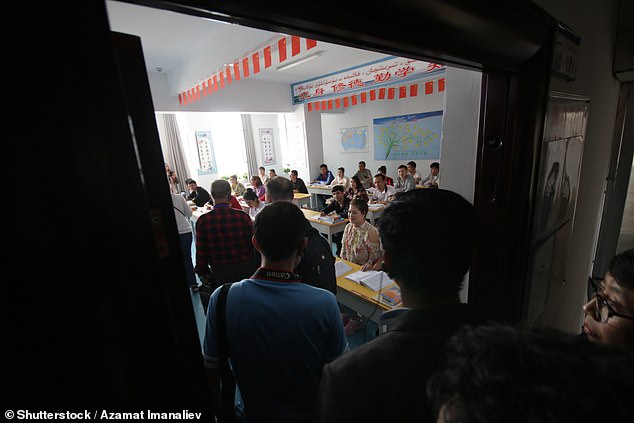 The US is among several countries to have previously accused Beijing of committing genocide in the Xinjiang province. Pictured: Uigurs learn Chinese language at reeducation camp in Xinjiang, 2019