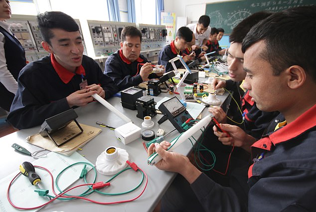 An image from inside the rarely seen confines of a detention centre, which appears to show Uyghurs being 're-educated'