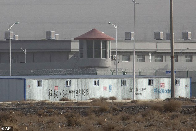 China's opaque justice system has long been criticised over the disappearance of defendants. Pictured: Guard tower and barbed wire fence are seen around a facility in Xiangjing