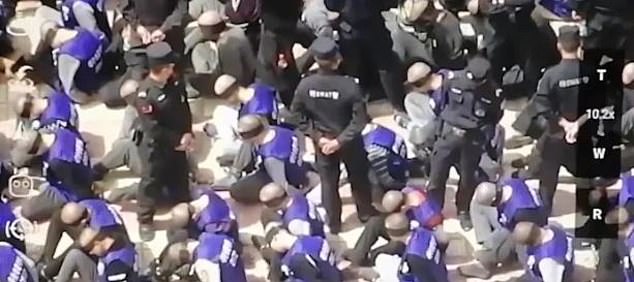 Drone footage emerged showing police leading hundreds of blindfolded and shackled men from a train in what was believed to be a transfer of inmates in Xinjiang