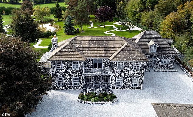 The huge mansion was decorated both inside and out with the doodle-like drawings